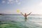 Woman plays frisbee in the water of beautiful ocean