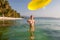 Woman plays frisbee in the water of beautiful ocean