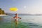 Woman plays frisbee in the water of beautiful ocean