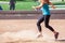 A Woman Plays a Game of Kickball