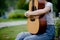 The woman plays the guitar happily. Cute, bright, happy to play music that loves music concepts