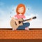 Woman plays guitar sitting on the wall