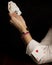 A woman plays poker with an ace of hearts tucked into the cuff of her white shirt