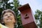 Woman pleased with birdhouses