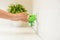 Woman plugging electric vaporizer with insect repellent liquid at home, closeup