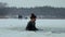 Woman plunging in ice hole in frozen river