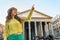 Woman pointing in front of pantheon in rome, italy