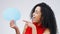 Woman, pointing and happy in studio with speech bubble, gesture and idea for promotion and advertising. Opinion, faq and
