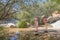 Woman pointing nature to her daughter in a river of Camorza Gorge near Madrid