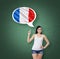 Woman is pointing out the thought bubble with French flag. Green chalk board background.