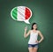 Woman is pointing out the thought bubble with Italian flag. Green chalk board background.