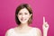 Woman pointing to somewhere, isolated on pink background