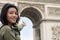 Woman pointing at the Triumphal Arch