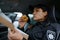 Woman police officer eating donut in car