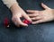 Woman polishing her nails on the gray background.