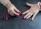 Woman polishing her nails on the gray background.