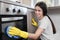 Woman polishing oven