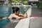 woman in pool play smartphone