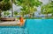 Woman by poolside. Resort swimming pool at Seychelles