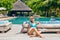 Woman by poolside. Resort swimming pool at Seychelles