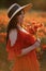 Woman poppy field red dress hat. Happy woman in a long red dress in a beautiful large poppy field. Blond stands with her