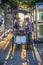 woman at a portable snack car offers fresh grilled chicken sticks on the street   in Bangkok