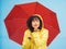 Woman, portrait or blowing kiss and rain umbrella on isolated blue background in Brazil city love or support. Black