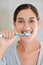 Woman, portrait and brushing teeth with smile in home for health, wellness or care for breath in morning. Girl, person