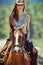 Woman, portrait and cowgirl with horse in countryside for ride, journey or outdoor adventure in nature. Female person or