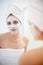 Woman, portrait and facial mask in mirror for skincare, .smile and bathroom for facial, beauty and cosmetic. Female
