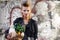 Woman, portrait and fashion with vegetable grocery in city, cool and punk rock hairstyle in leather jacket by graffiti