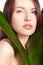 Woman portrait with green leaf