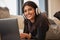 Woman portrait, headphones and computer video streaming with music feeling happy in a living room. Indian person with