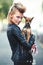 Woman, portrait and leather jacket with pet, smile and rock n roll for unique in punk fashion and love for pet chihuahua