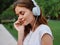 Woman portrait meditation and tranquility in headphones happiness smile with her eyes closed in a white T-shirt