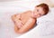 Woman, portrait and milk bath with flower petals and luxury bathroom treatment with smile. Body care, cleaning and