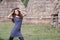 Woman pose front of straw houses