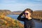 Woman poses at the Lake of the Clouds overlook in the Porcupine Mountains Wilderness in the Upper Peninsula of Michigan