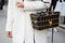 Woman poses for photographers with golden Savas Caroline basket bag with deer before Fendi fashion show,
