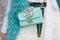 Woman poses for photographers with turquoise bag with jewels before Costume National fashion show, Milan