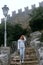 Woman Posing against the backdrop of the fortress, steps, stairs. Mystical atmosphere, fog and mist. Vertical photo. Pass of the