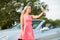 Woman posing at convertible car and taking selfie