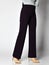 Woman posing in dark purple classic pants