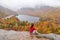 Woman posing in front of beautiful Echo Lake from Artists Bluff Loop in New Hampshire USA