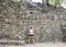 Woman posing in front of a Ruin in the COBA Zona Arqueologica