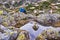 Woman posing on rocks, with the sky reflecting in the glacial lake Bucura, in Retezat mountains Carpathians, Romania.