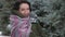 Woman is posing with shawl in winter forest, beautiful landscape with snowy fir trees