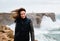 Woman posing standing on the edge of cliff Atlantic Ocean on background. Algarve. Portugal