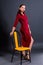 Woman posing standing leaning on chair