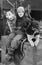 Woman posing with two sled dogs